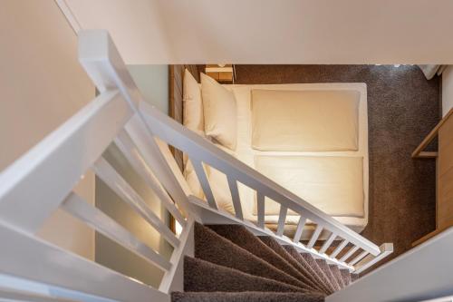 a staircase leading up to a room with a bed at SANDnature in Timmendorfer Strand