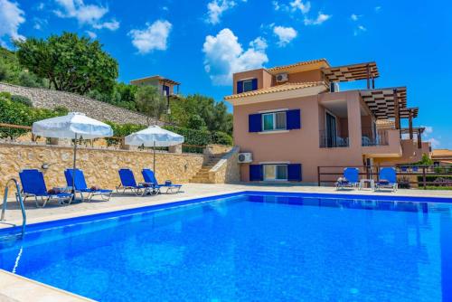 a villa with a swimming pool and a house at Villa Andromeda in Sivota