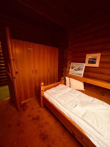 a bedroom with a bed in a wooden room at Haus an der Planai (Pistenzugang & Panoramablick) in Schladming