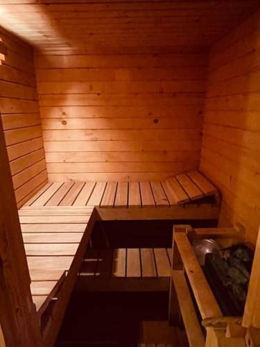 an empty wooden sauna with a sink in it at Haus an der Planai (Pistenzugang & Panoramablick) in Schladming