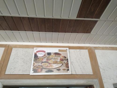 a picture of a plate of food on a ceiling at Kuber's Residency in Mahad