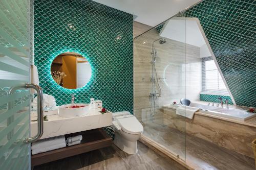 a bathroom with a toilet and a sink and a shower at Grand Fleuve Boutique in Ha Long