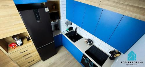 an overhead view of a toy kitchen with blue cabinets at Pod Brzozami Apartamenty Let's Sea Gąski in Gąski