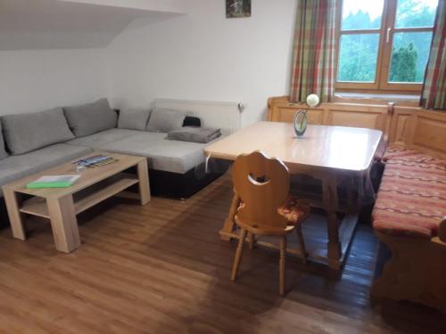 a living room with a couch and a table at Haus Guggemos in Hopferau