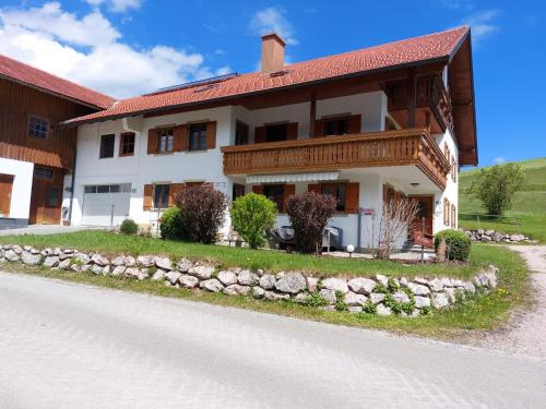 a large white house with a red roof at Haus Guggemos in Hopferau