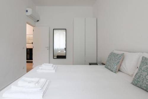 a white bedroom with a large white bed at LOVELY MILANO - Lovely Porta Romana in Milan