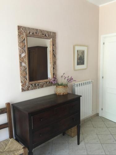 a room with a dresser and a mirror on the wall at La Famiglia in Vasanello