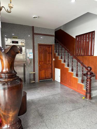 a hallway with a staircase and a wooden stair case at Bao Chieu Inn in Ha Tien