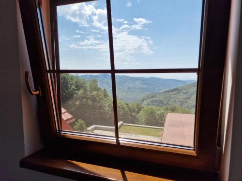 a window with a view of a mountain view at Wellness hotel Chata Jana in Lopeník
