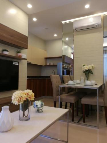 a kitchen and living room with a table and chairs at Adria Residences - Ruby Garden - 2 Bedroom for 4 person in Manila