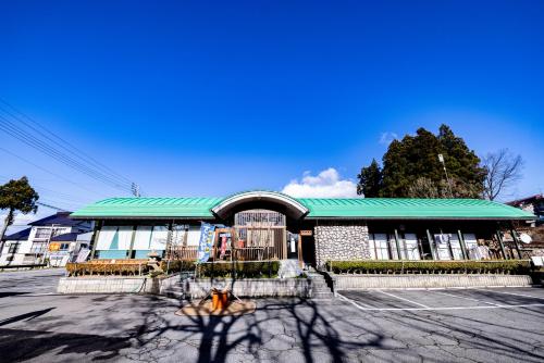 a building with a green roof in a parking lot at Bandai in Tokamachi