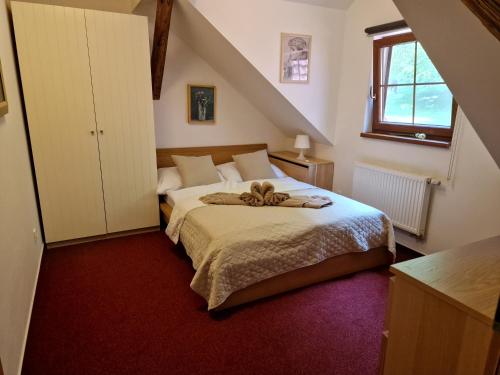 a bedroom with a large bed in a attic at Wellness hotel Chata Jana in Lopeník