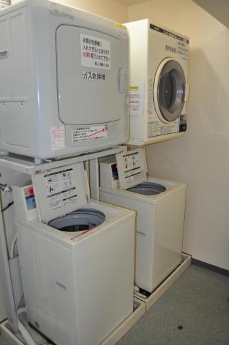 a stack of washing machines and a washer and dryer at Kochi Ryoma Hotel in Kochi