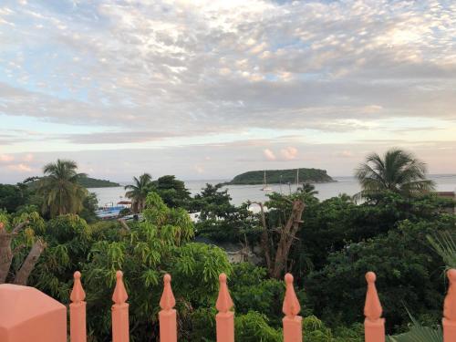 a view of the ocean from the balcony of a house at Esperanza Inn Guesthouse in Vieques