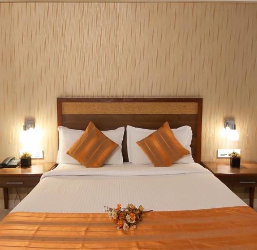 a bedroom with a large bed with flowers on it at Quality Inn Mint in Pune