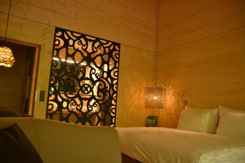 a bedroom with a bed with a black and white gate at Hotel Rovanada Wellness & BergNatur in Vals