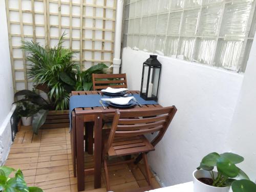 d'une table et de chaises sur un balcon orné de plantes. dans l'établissement Appartement Thida, à Paris