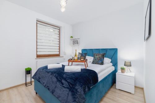 Ένα ή περισσότερα κρεβάτια σε δωμάτιο στο Bunscha Apartment Dębniki Cracow by Noclegi Renters