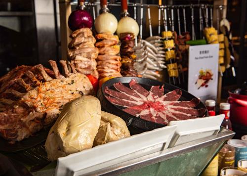 a buffet with meat and other foods on display at Futian Shangri-La, Shenzhen,Near to Shenzhen Convention&Exhibition Centre, Futian Railway Station in Shenzhen