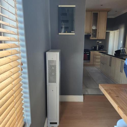a kitchen with a refrigerator in the corner of a room at Waves Edge CP3 in Cape Town