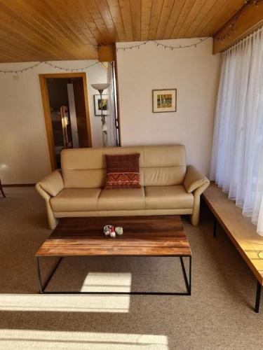 a living room with a couch and a coffee table at Charming and cosy apartment (sleeps 4-6 people) in a beautiful mountain village in Mürren
