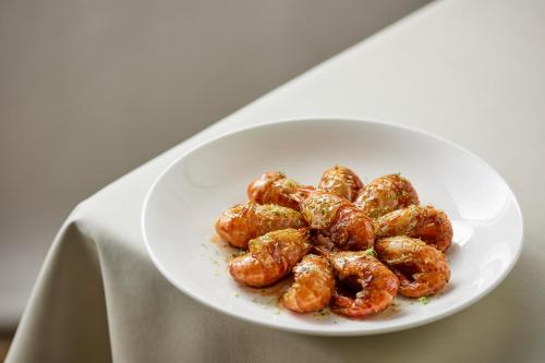 a white plate of food on a table at Futian Shangri-La, Shenzhen,Near to Shenzhen Convention&Exhibition Centre, Futian Railway Station in Shenzhen