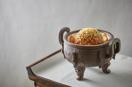 a bowl filled with rice and carrots on a table at Futian Shangri-La, Shenzhen,Near to Shenzhen Convention&Exhibition Centre, Futian Railway Station in Shenzhen