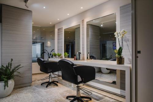 a bathroom with a desk and chairs in a room at Alion Beach Hotel in Ayia Napa