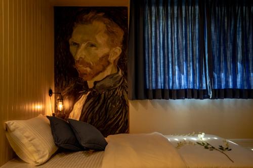 a painting of a man in a room with a bed at Ra Residence - Agarwal Group of Hotels in Pune