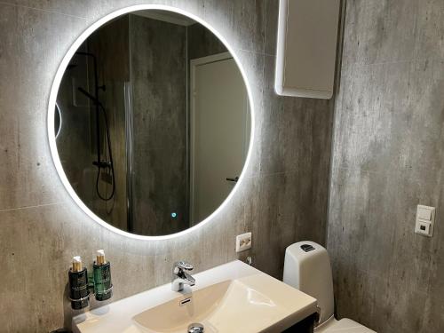 a bathroom with a sink and a mirror at Stryn House - Hotel & Apartments in Stryn