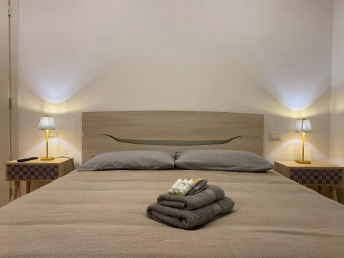 a bedroom with a bed with towels on it at LHE Les Trois Merveilles in Cesena