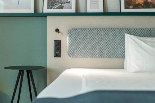 a bedroom with a bed and a small table at Hotel Münchwilen in Wil