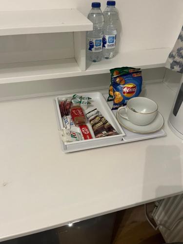 a drawer with food and drinks on a kitchen counter at TJ Homes - Luxury Studio Suite with Garden View - Next to tube station London in Ruislip