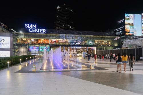 a fountain in the middle of a mall at night at GROOVE AT SIAM in Pom Prap