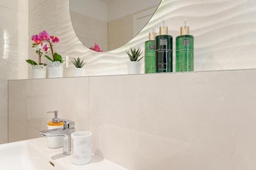 a bathroom with a sink and some plants on a shelf at Seven Seas Residence in Split