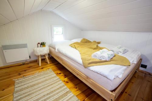 a bedroom with a bed in a small room at ACTIVFARM DOMKI NA KASZUBACH Domek Piotruś in Gliśno