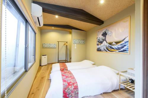 a bedroom with a bed and a large window at Benkei in Kyoto