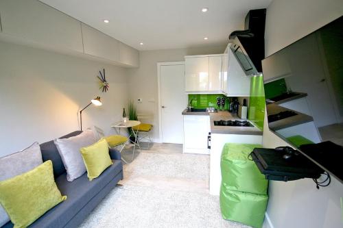 a living room with a couch and a kitchen at Sunridge EcoPod with Private Hot Tub in Plymouth