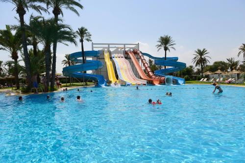 a group of people in the water at a swimming pool at One Resort Jockey Monastir in Monastir