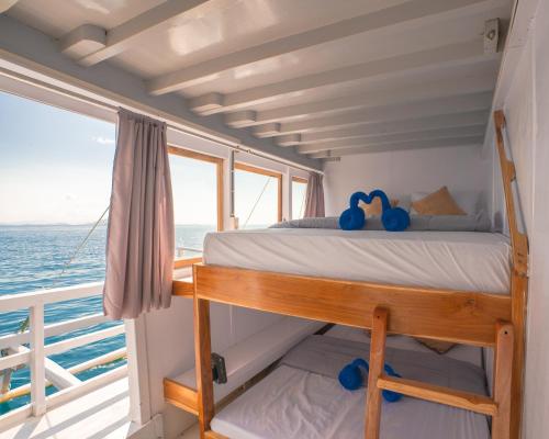 a bed in a room on a boat at Open trip Labuan Bajo in Labuan Bajo