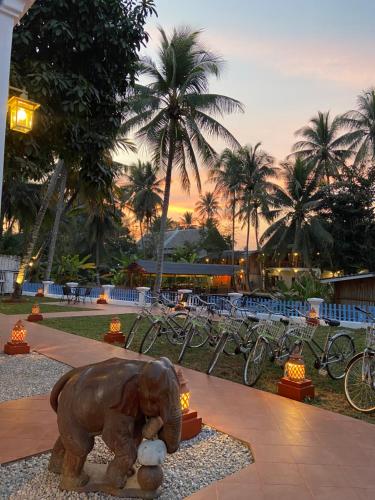 a statue of an elephant with a teddy bear at Sadakham Hotel in Luang Prabang