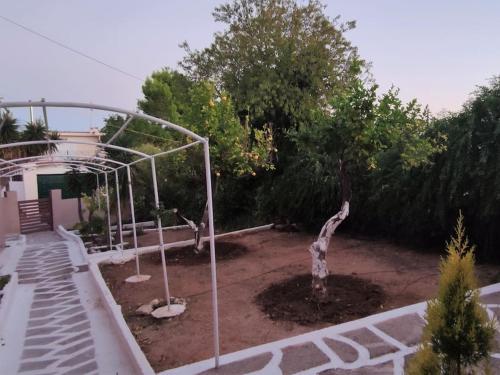 a basketball hoop in a yard with a tree at Penthouse Studio next to the Sea in Salamís