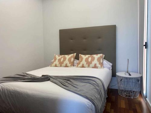 a bedroom with a large bed with two pillows at Villa Calm Ocean views by Infinity Summer in La Playa de Arguineguín