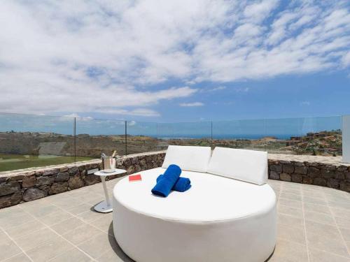 a large white tub sitting on a patio with a view at Villa Calm Ocean views by Infinity Summer in La Playa de Arguineguín