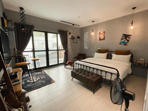 a bedroom with a bed and a living room at Living House in Hengchun