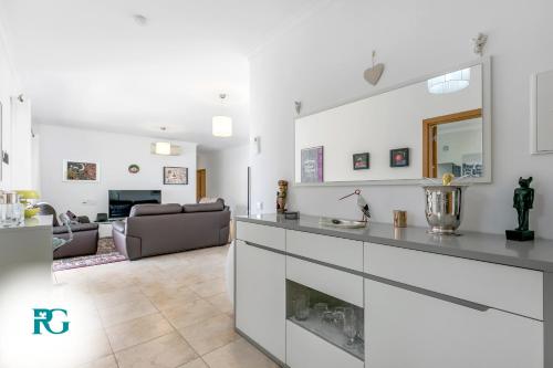 a kitchen and living room with white walls and a couch at Luxury Penthouse Near City Center #1933 in Lagos