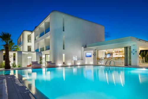 a swimming pool in front of a house at Cocoοns Suites & Villas Fourka in Fourka