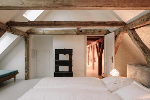 a bedroom with a white bed in a attic at Apartment Alte Schmiede in Saal