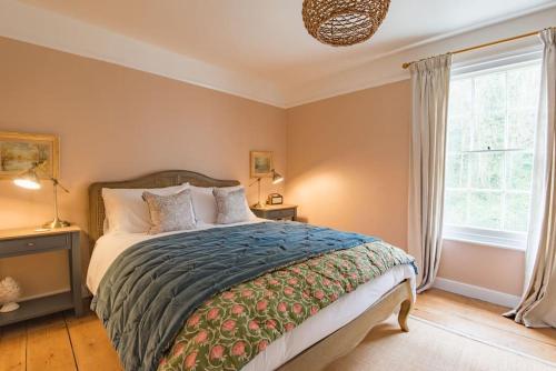 a bedroom with a bed and a window at Cliffeside Cottage in Kingsdown