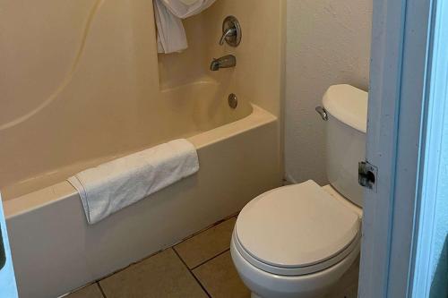 a bathroom with a white toilet and a bath tub at Daysinn in Branson